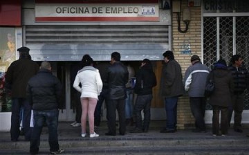 People wait to enter a government-run employment office in Madrid, Jan. 3, 2013.