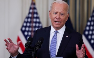 U.S. President Joe Biden responds to a question from a reporter after speaking about coronavirus disease (COVID-19) vaccines and booster shots in the State Dining Room at the White House in Washington, U.S., 