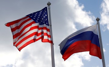 Russian and U.S. state flags fly near a factory in Vsevolozhsk, Leningrad Region, Russia