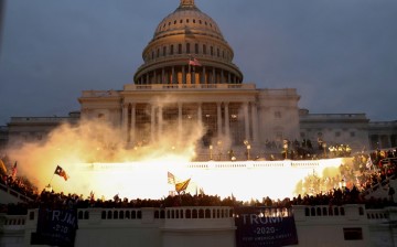 An explosion caused by a police munition is seen while supporters of U.S. President Donald Trump gather in front of the U.S. Capitol Building in Washington, U.S.