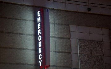 An emergency sign illuminates outside of George Washington University Hospital, one of roughly 400 Universal Health Services, Inc (UHS) facilities across the United States and the U.K.
