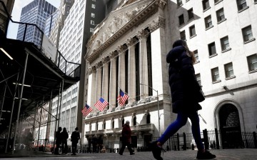 People are seen on Wall Street outside the New York Stock Exchange (NYSE) in New York City, U.S., 