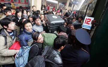 Chinese travelers fighting their way to enter the train during Spring Festival travel peak.