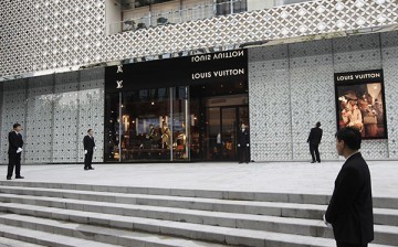 Men guard a Louis Vuitton store in Shanghai.
