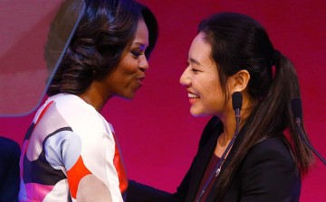 First Lady Michelle Obama (L) is greeted before a presentation on free speech at Peking University.