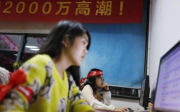 Employees of Tmall, part of Alibaba, work online to serve customers.