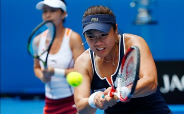 Chan Yung-Jan (R) of Taiwan hits a return as Zheng Jie looks on during their match at the 2015 Australian Open in Melbourne.