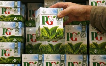 A shopper picks up a box of PG Tips tea bag made by Unilever.