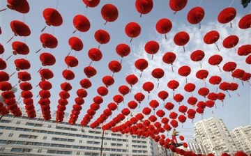 A worker prepares red lantern decorations for the Spring Festival Temple Fair at the entrance to Ditan Park in Beijing, Jan. 20, 2009.
