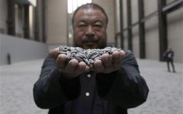Chinese artist Ai Weiwei poses with an art installation. 