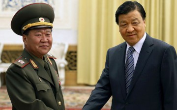 Liu Yunshan (right), a senior Chinese Communist party official, poses for the cameras.