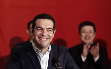 Greek Prime Minister Alexis Tsipras smiles during his speech aboard the Chinese frigate Changbaishan. 