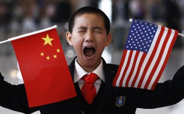 A boy yawns while awaiting Hilary Clinton's arrival in Beijing.