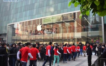 Customers wait in front of the newly opened Apple Store in Shenyang, China.