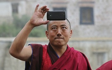 A Tibetan monk takes a picture of himself, a 