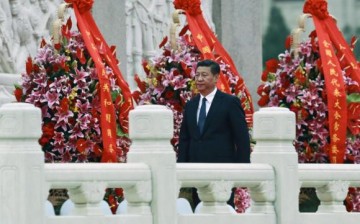Chinese President Xi Jinping walks during a memorial ceremony.