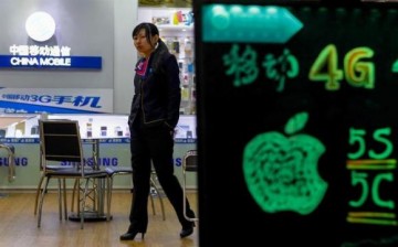 A sales assistant walks inside a China Mobile store in China.