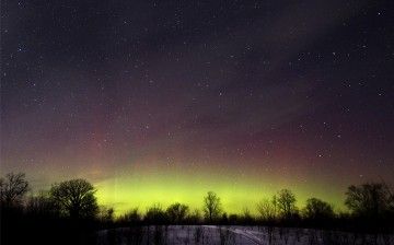 The glow of the Aurora Borealis, or Northern Lights, is seen in the horizon in the Kawartha Lakes region, southern Ontario February 23, 2015. The colorful cosmic display of the northern lights is rarely seen in Ontario. 