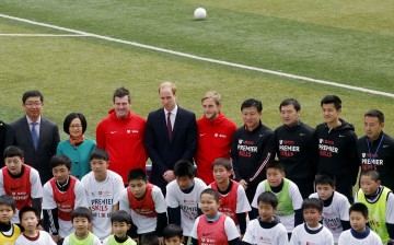 Britain's Prince William (rear C) poses for a group picture during a visit to a Premier League training camp at Nanyang Secondary School in Shanghai, March 3, 2015. 