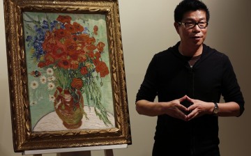 Wang Zhongjun, chairman of Huaiyi Brothers Media, stands beside Vincent van Gogh's 