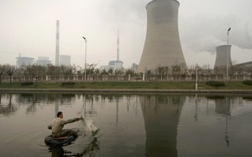 A man fishes near a thermal power plant in Tianjin.