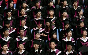 Graduating students of Tsinghua University listen during a commencement exercise.