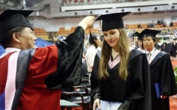 An international student graduates from a Chinese university, one among thousands who self-finance their study.