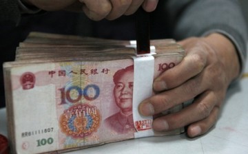 A stack of yuan banknotes sealed by an employee at a branch of Industrial and Commercial Bank of China in Huaibei, Anhui Province.