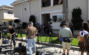 Media are seen outside the apartment where kidnap victim Denise Huskins was staying in Huntington Beach
