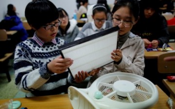Students learn how to make the do-it-yourself (DIY) air purifier at a college in Beijing, in a workshop sponsored by a company that invented the DIY air filter.