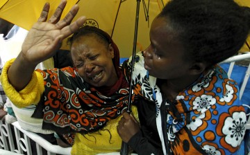 A woman reacts after seeing her son who was rescued from the Garissa University attack