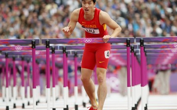 China's Liu Xiang looks up after kissing the last hurdle in his lane during his men's 110-meter hurdles round 1 heat at the London 2012 Olympic Games.