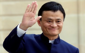 Alibaba founder and chairman Jack Ma waves to onlookers during a meeting with French President Francois Hollande in Paris, March 18, 2015.