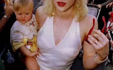 Kurt Cobain (L, behind baby), with wife Courtney Love and daughter Frances Cobain seen here in a file photo.