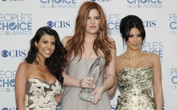 Reality television sisters (L-R) Kourtney, Khloe and Kim Kardashian pose with their favorite guilty pleasure award for 'Keeping Up with the Kardashians' at the 2011 People's Choice Awards in Los Angeles January 5, 2011