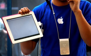 An Apple store employee gives a class on how to use the iPad 2 at an Apple Store in central Beijing. 