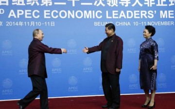 Russia's Vladimir Putin and China's Xi Jinping shake hands as a symbol of continued diplomatic ties between the two countries.