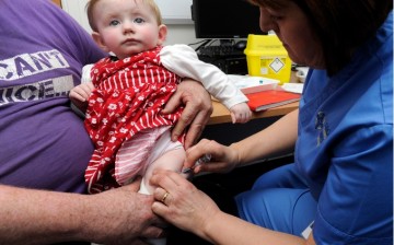 A child is given an MMR injection