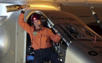 Swiss pilot Bertrand Piccard raises a bottle of champagne after landing the Solar Impulse 2 plane on April 22, 2015, at Nanjing Lukou International Airport, Jiangsu Province.