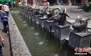 A photo taken on April 25, 2015, shows copies of 12 Yuanmingyuan animal head sculptures spraying water on the street in Taiyuan, capital of north China's Shanxi Province. 