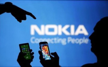 Nokia smartphones are photographed with the Nokia logo on the background.