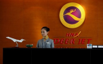 An attendant on duty at her desk inside the business jet terminal of Hainan Airline Group at Shenzhen Bao An International Airport in the southern Chinese city of Shenzhen.