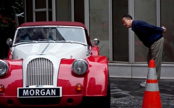 A local resident looks at a Morgan sport car during the opening of China's first Morgan sport cars showroom in Shanghai.