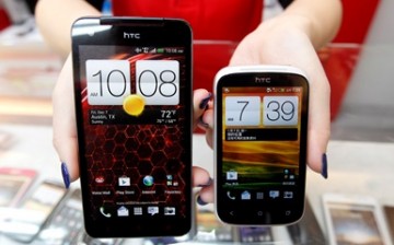 A mockup of an HTC Butterfly smartphone and a Desire C smartphone are displayed in a mobile phone shop in Taipei.