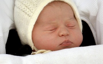 The baby daughter of Britain's Prince William and Catherine, Duchess of Cambridge, sleeps as she is carried in a car seat from the Lindo Wing of St. Mary's Hospital, in London, Britain May 2, 2015.