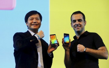 Xiaomi executives Lei Jun and Hugo Barra display Mi 4i phones during its launch in New Delhi.