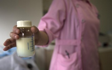 A nurse at Guangzhou Women and Children's Medical Center in southern China presents a donated bottle of breast milk.
