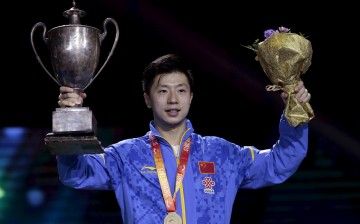 Ma Long poses with his gold medal and trophy for the men's singles final at the World Table Tennis Championships in Suzhou on May 3, 2015.