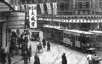 An old-style tram shuttles citizens about their day in 1920s Shanghai.