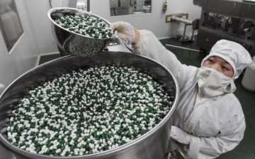 A worker packs Chinese patent capsules in a drug factory in China. 